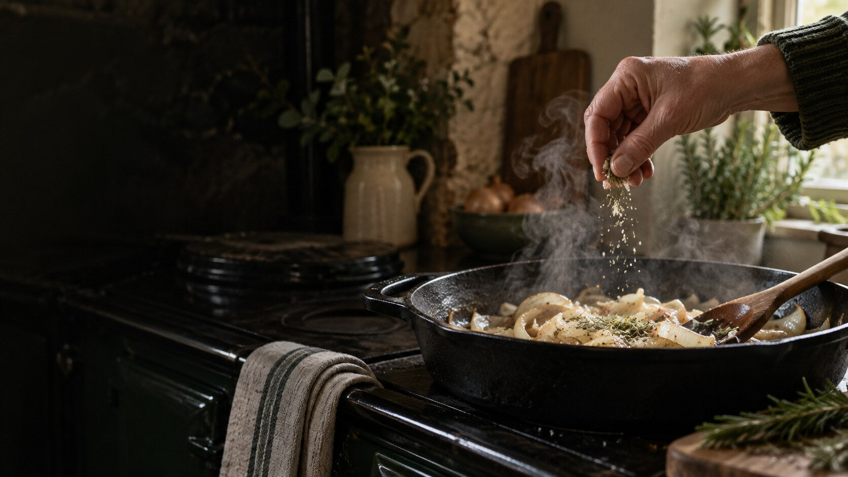 A small pinch of herb seasoning being added while onions cook